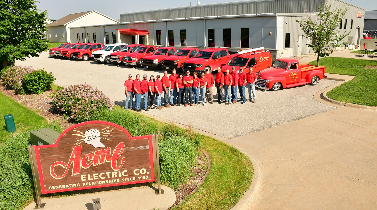 Acme Electric whole team in front of building